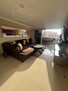 a living room with a couch and a table at Apartamento Costa Azul Oasis frente CC La Vela in Porlamar