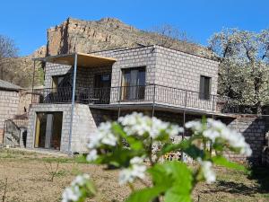 a stone house with a mountain in the background at Arevot Ojakh in Areni