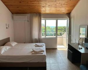 a bedroom with a bed and a sink and a window at Siana House in Ravda +21 photos