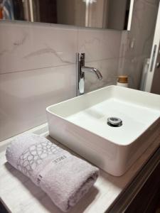 a white bathroom sink with a towel on a counter at Aurora sul mare in Terracina