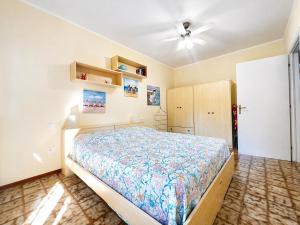 a bedroom with a bed and a ceiling fan at Dimora Scacciapensieri a Marina di Cecina by Zoom In Earth in Marina di Cecina
