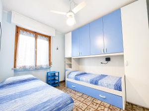 a bedroom with blue cabinets and a bed at Dimora Scacciapensieri a Marina di Cecina by Zoom In Earth in Marina di Cecina