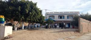 two people riding bikes in front of a building at dar fatma matmata in Matmata +4 photos