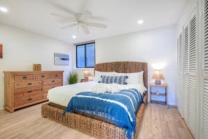 a bedroom with a bed and a ceiling fan at Oceanfront 2BR - Private Patio - Steps to Beach in Carlsbad