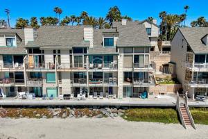 an aerial view of a large apartment building on the beach at Oceanfront 2BR - Private Patio - Steps to Beach in Carlsbad