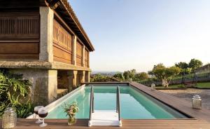 a swimming pool on a deck next to a house at Villa Miranda Heritage House in Creixomil
