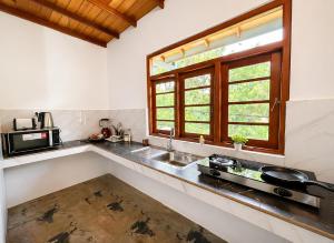 a kitchen with a sink and a window and a stove at Sonic Villa,Beruwala in Beruwala +20 photos