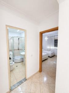 a bathroom with two sinks and two toilets at H&G Seaview Apartments in Durrës +35 photos