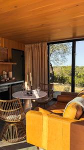 a living room with a yellow couch and a table at Lagom Retreat in Dripping Springs