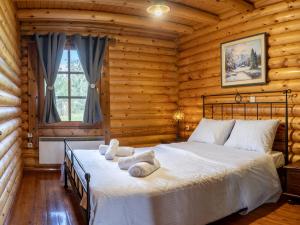 a bedroom with a bed in a log cabin at Mountain Escape Chalet in Karpenisi