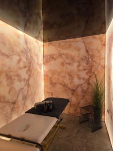 a bathroom with a table and a marble wall at Sianisia Adults Only & Private Spa in Haţeg