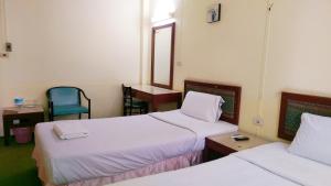 Katil atau katil-katil dalam bilik di โรงแรมวัฒนาตรัง