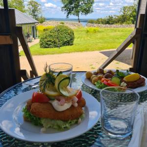 a table with two plates of food on it at Tostarps Pensionat in Hässleholm