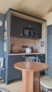 a kitchen with a table and a counter with a sink at Chalet Villerest in Villerest