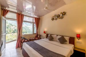 a bedroom with a bed and a large window at Art-llers Homestay in Dharmsāla
