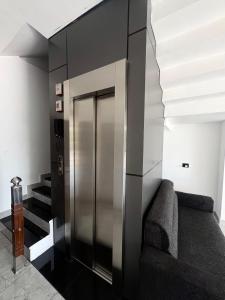 a elevator in a room with a couch and stairs at Mahadeva Residency in Trivandrum