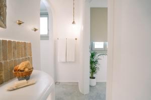 a bathroom with a white tub and a plant at Turquoise in Platis Gialos +152 photos