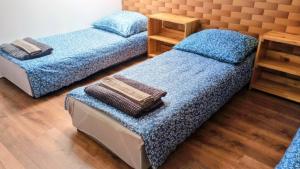 two twin beds in a room with wooden floors at Chmurka in Górno