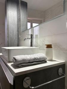a bathroom with a sink and a towel on a counter at Aurora sul mare in Terracina