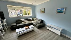 a living room with a couch and a table at 3 bedroom cottage in Lamlash