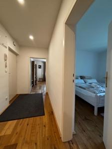 a bedroom with a bed and a hallway at Wien an Donau in Vienna