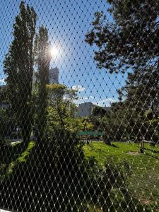 a fence in a park with the sun behind it at Wien an Donau in Vienna