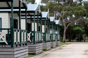 a green and white house with a porch at Geelong Surfcoast Hwy Holiday Park in Mount Duneed