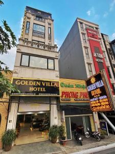 a building with a hotel on a city street at Golden Hotel in Hanoi