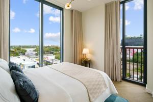 a bedroom with a large bed and large windows at The 27 Wynwood in Miami +135 photos