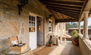 an outdoor patio with a door and a table at Villa Miranda Heritage House in Creixomil