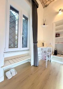 an empty room with a window and a chair at Ponte Milvio Roma Elegance Room & Private Parking in Rome