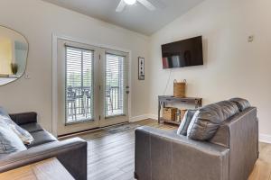a living room with two couches and a tv at Pool Access! Recently Updated Coastal Retreat in Foley