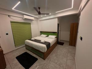 a bedroom with a bed and a green door at Mahadeva Residency in Trivandrum +18 photos