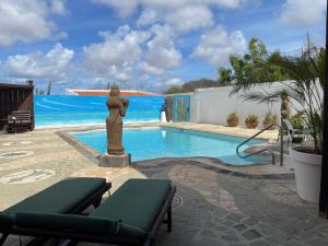 a swimming pool with a statue in front of it at Via Monica in Santa Cruz