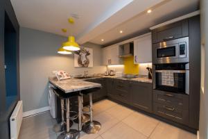 a kitchen with gray cabinets and a counter top at The Lookout Holmfirth in Holmfirth