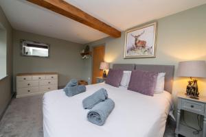 a bedroom with a bed with towels on it at The Lookout Holmfirth in Holmfirth +6 photos