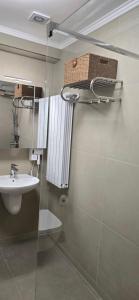 a bathroom with a sink and a toilet and a mirror at Vila CLASS in Vatra Dornei +28 photos