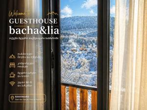 a window with a view of a snow covered mountain at Guesthouse Bacha Lia in Mestia