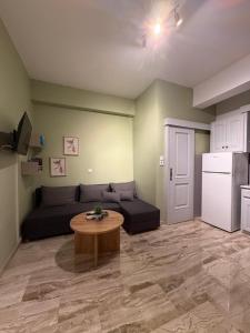 a living room with a couch and a table at Sea&Nature apartment in Aigio