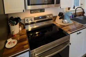 a kitchen with a stove and a counter top at Seward Mountain View Cabins #10 in Seward