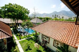 an aerial view of a resort with a pool at Mimpi Nyata by Phocéa in Pemuteran