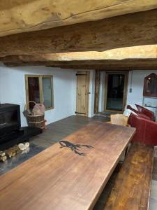 a living room with a wooden table and a couch at Grange aménagée in Campan