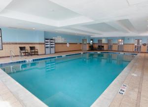 a large swimming pool with blue water at Holiday Inn Express & Suites Logan by IHG in Logan