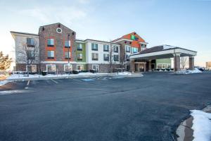 an empty parking lot in front of a building at Holiday Inn Express & Suites Logan by IHG in Logan