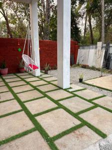 a patio with a hammock in a yard at 1BR Nest in Varkala