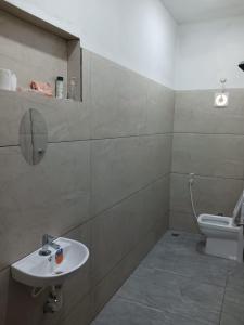 a bathroom with a sink and a toilet at 1BR Nest in Varkala