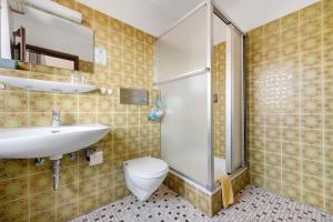 a bathroom with a toilet and a sink and a shower at Gästehaus Brigitte in Freudenstadt +24 photos