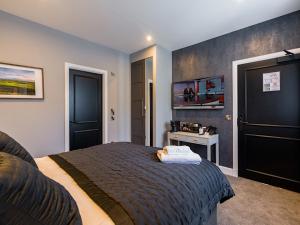 a bedroom with a large bed and a desk at Hotel 30 Five in Aberdeen