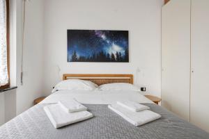 a bedroom with a bed with two pillows on it at Juliet in Levanto