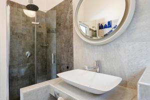 a bathroom with a sink and a shower with a mirror at Juliet in Levanto +24 photos